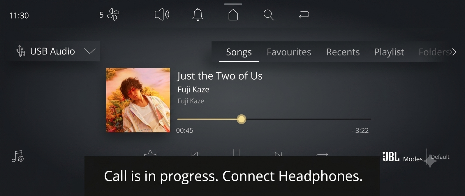 Passenger display showing media paused with connect headphones prompt during driver call